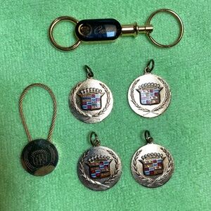 Six Cadillac Gold Tone Key Charms.